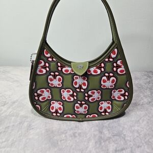 Coach Pebble Turnlock Hobo or Legacy Flap shoulder bag, specifically in a pebble